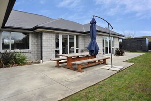 Enjoy a peaceful retreat in this stylish home with a patio, complete with a picnic table and lush garden.