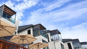 A modern building with multiple balconies and large windows. - The Marine Pool Villa (Gyeongju)