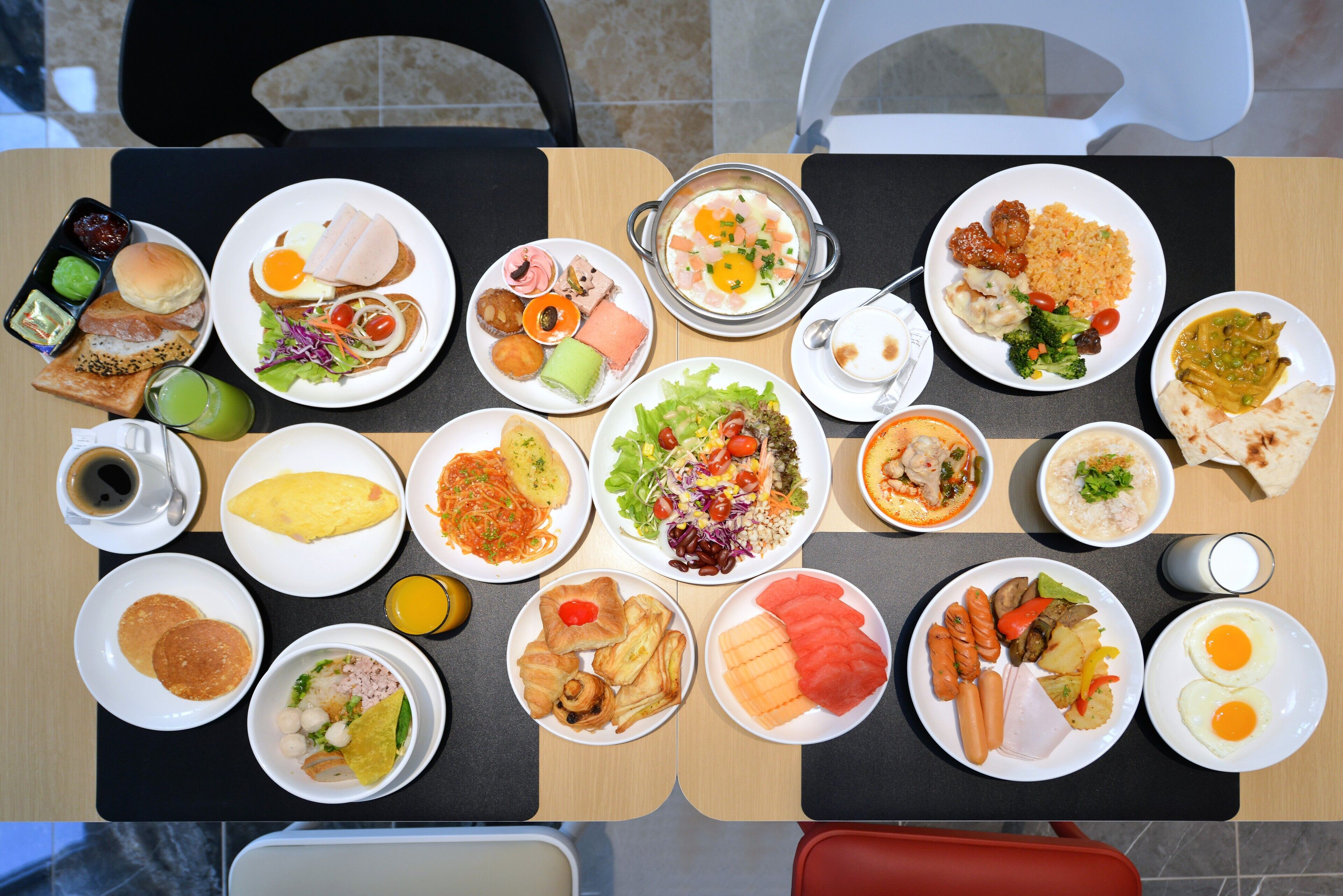 A table with various dishes including eggs, vegetables, and meats, suggesting a meal setting.