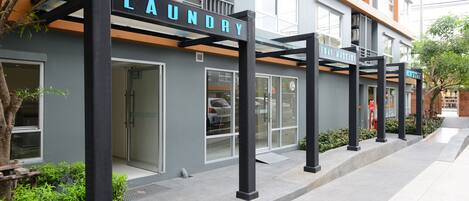 A building with a laundry facility, a massage center, and a reception area.