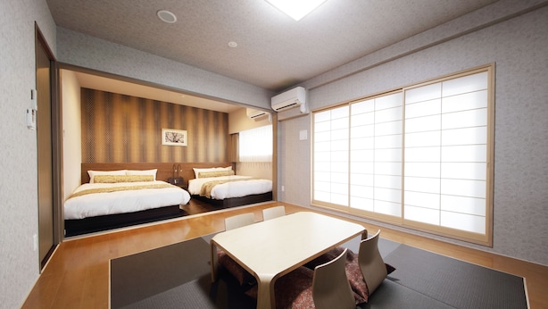 A hotel room with two beds, a dining table, and a large window. - SARASA HOTEL Shinsaibashi (Osaka)