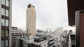 A hotel with a rooftop terrace, surrounded by high-rise buildings in an urban setting. - SARASA HOTEL Shinsaibashi (Osaka)