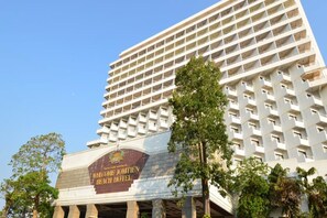 A high-rise hotel with a large sign reading "Welcome to Jomien Beach Hotel".