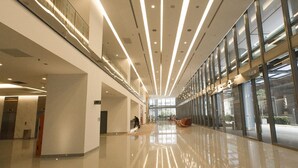 A spacious, modern lobby with a high ceiling, reflective floor, and large windows allowing natural light. - Summer Suites Vacation Home (Kuala Lumpur)