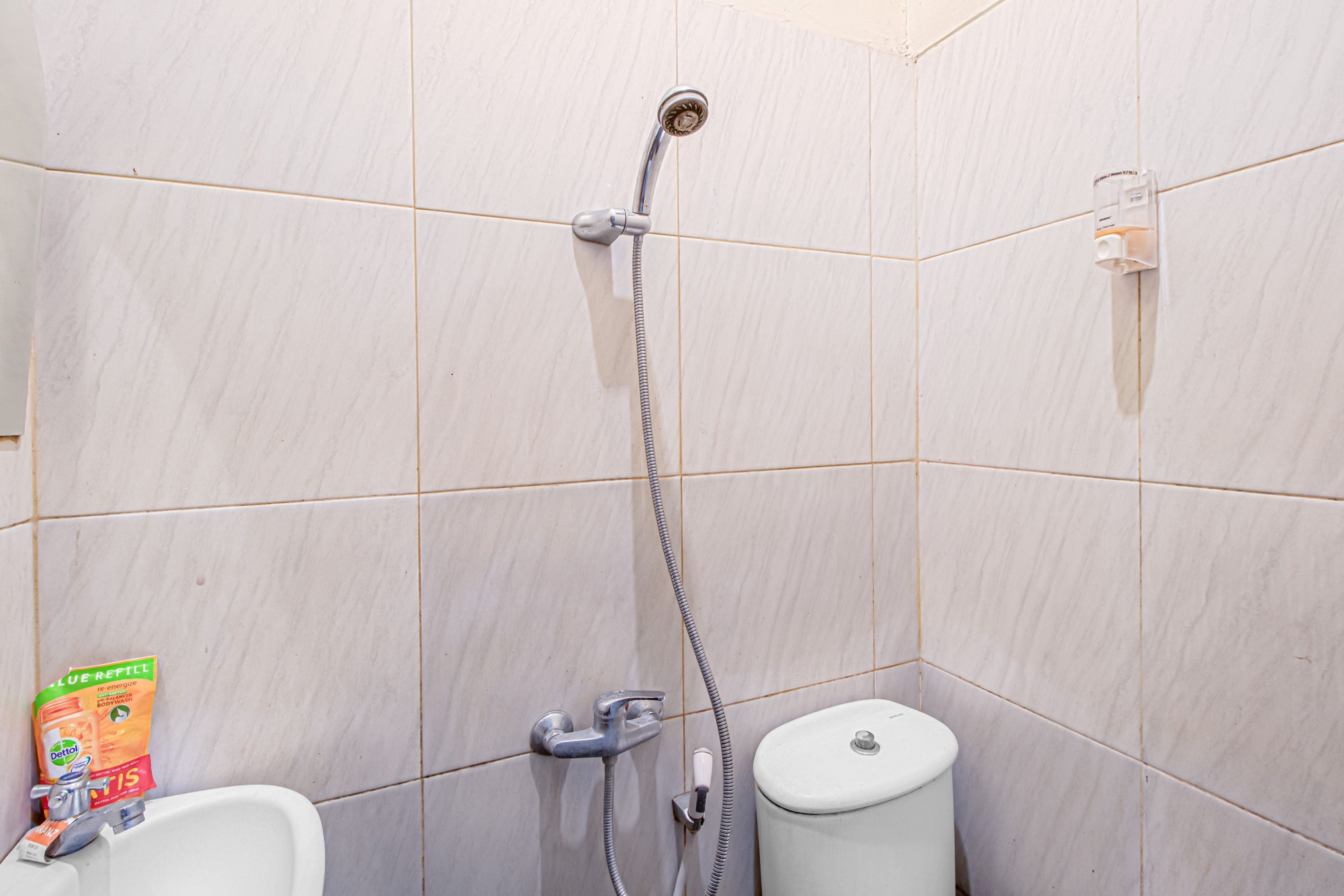 A bathroom with a shower, toilet, and a sink.