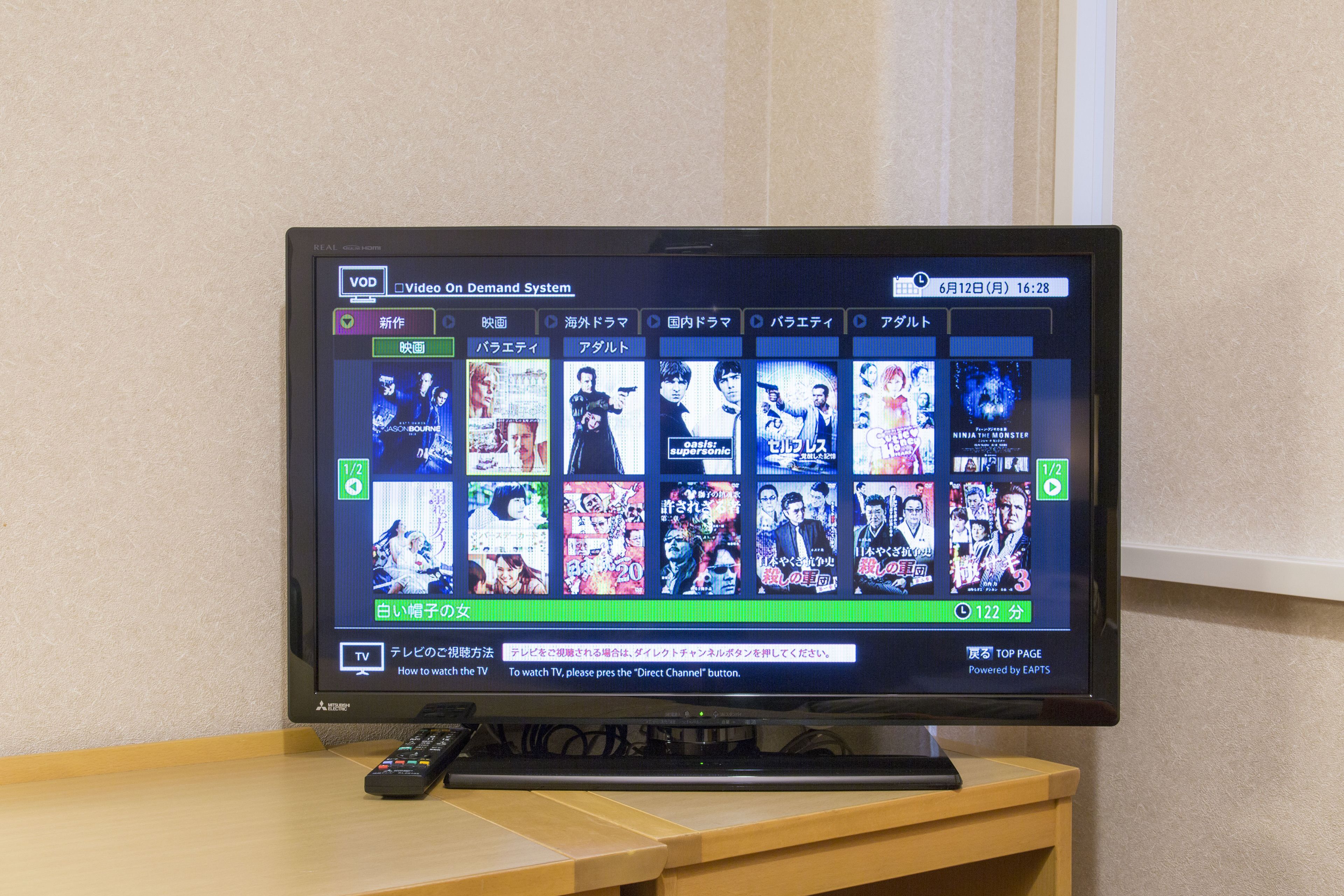 A television displaying a video on demand system with various movie thumbnails.