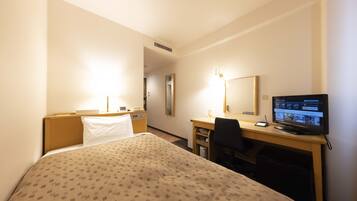 A hotel room with a bed, desk, chair, television, and a mirror.