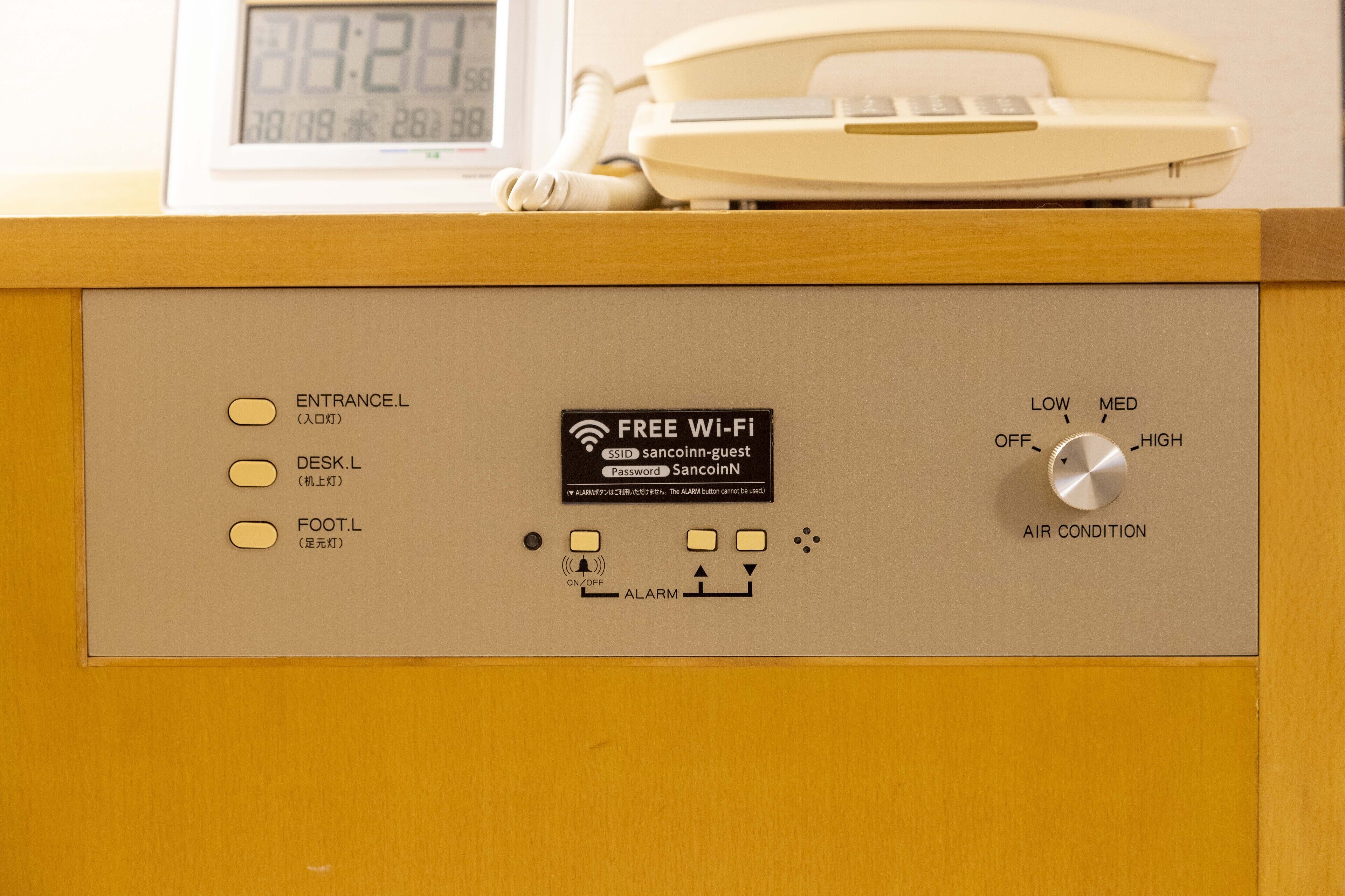 A control panel with buttons for entrance, desk, and foot, a free Wi-Fi sign, an alarm button, and an air condition knob.