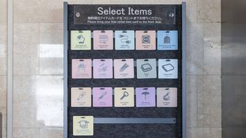 A wall-mounted sign listing various rental items with icons and descriptions.