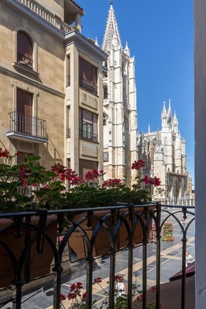 A building with a gothic architectural style, featuring pointed arches and a spire. - Hostal Albany Ancha (León)