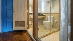 A modern bathroom with a glass shower enclosure, a wooden door, and a blue door. - THE Posh Phayathai (Bangkok)