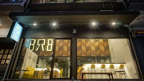 A modern building with large windows and a sign reading "BR8". - BRB Hostel Bangkok Silom (Bangkok)