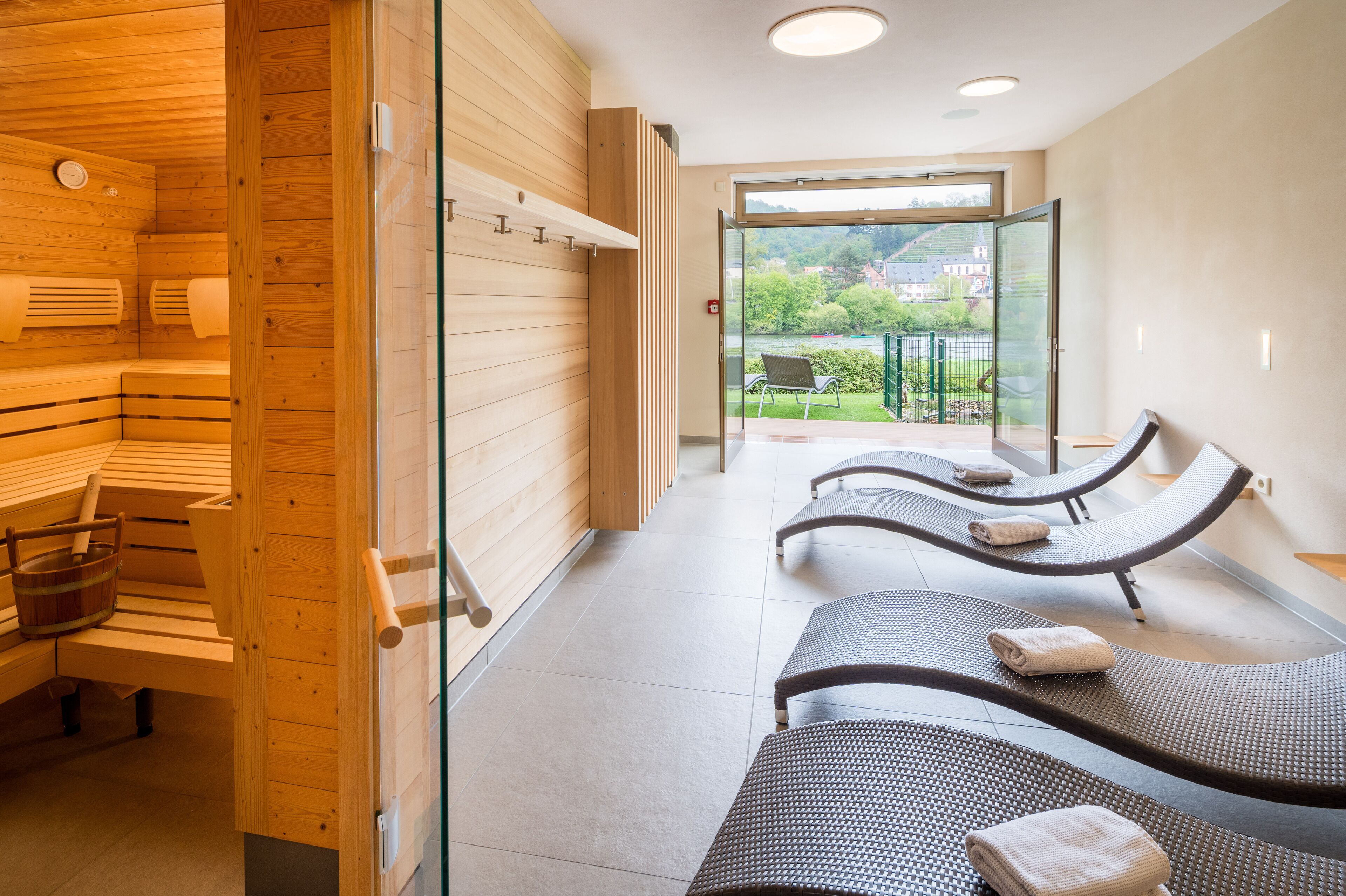 A sauna room with wooden benches and benches with towels.