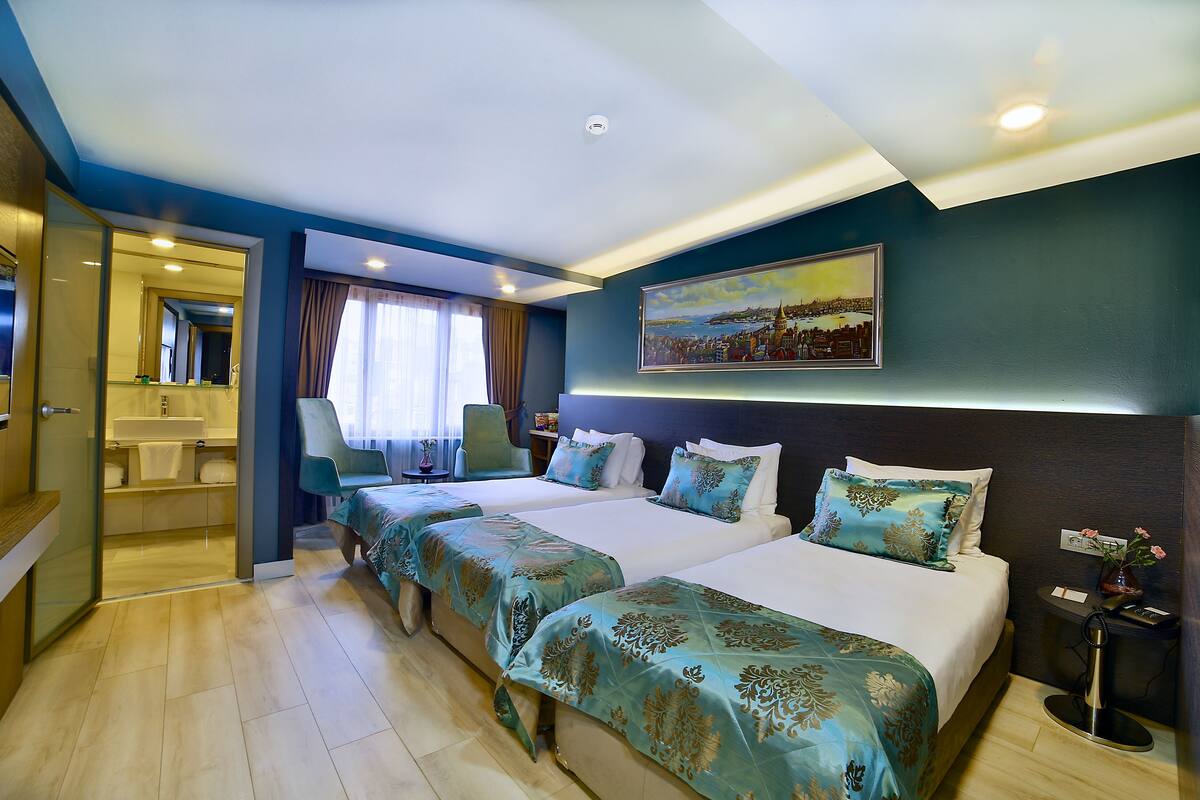 Standard Triple Room | Minibar, in-room safe, soundproofing, iron/ironing board (on request)