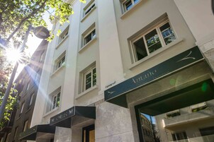 A multi-story building with a cafe named "Anzano" on the ground floor.