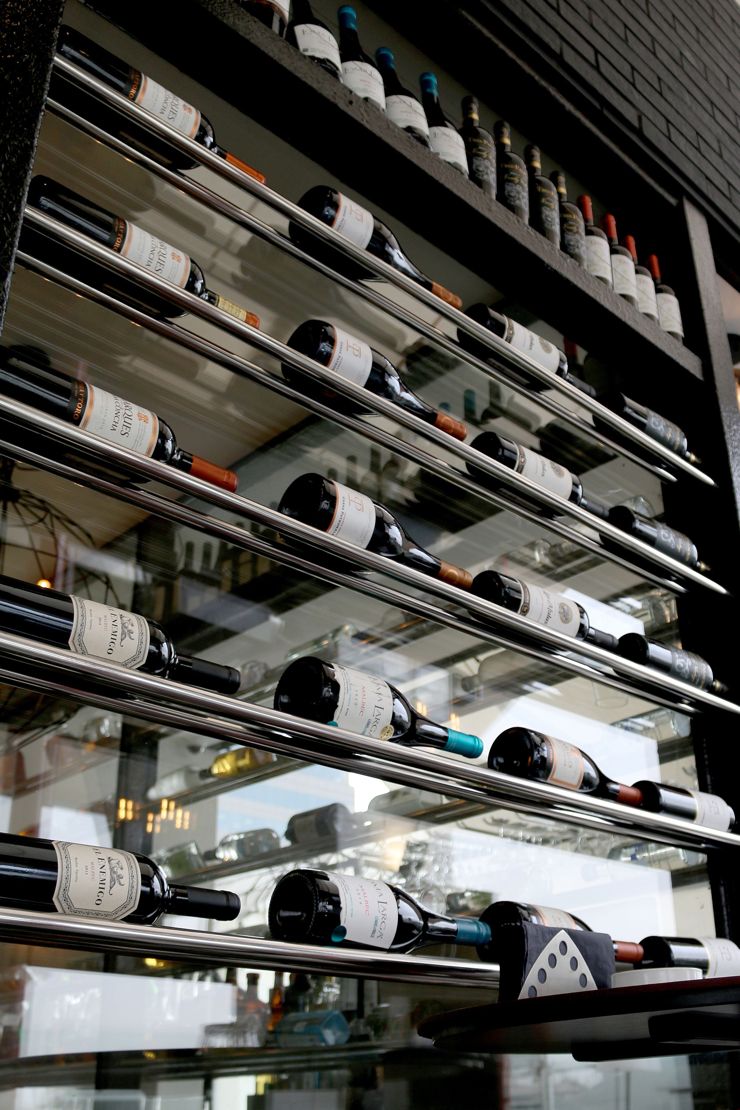 A wine rack with multiple bottles of wine.