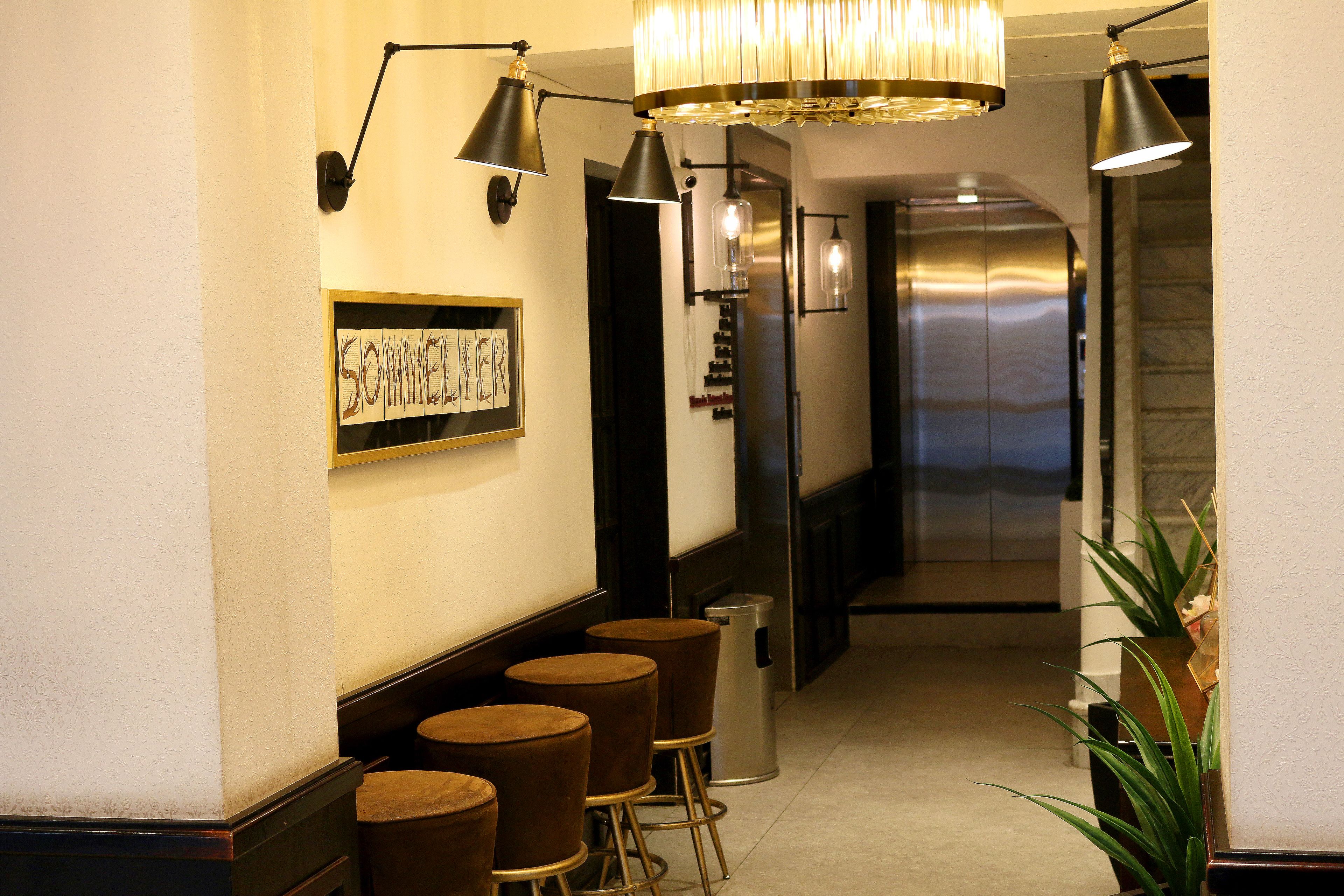 A hallway with a bar area featuring stools and a sign that reads "SOMMER".