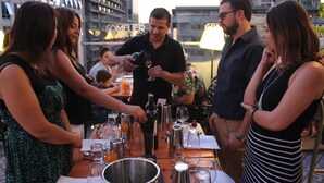 Un grupo de personas en un área de comedor al aire libre, con un paisaje urbano de fondo.