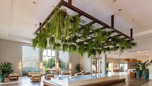 A spacious lobby with a large indoor pool, seating areas, and a reception desk. - Rio Quente Resorts - Cristal Resort (Rio Quente)