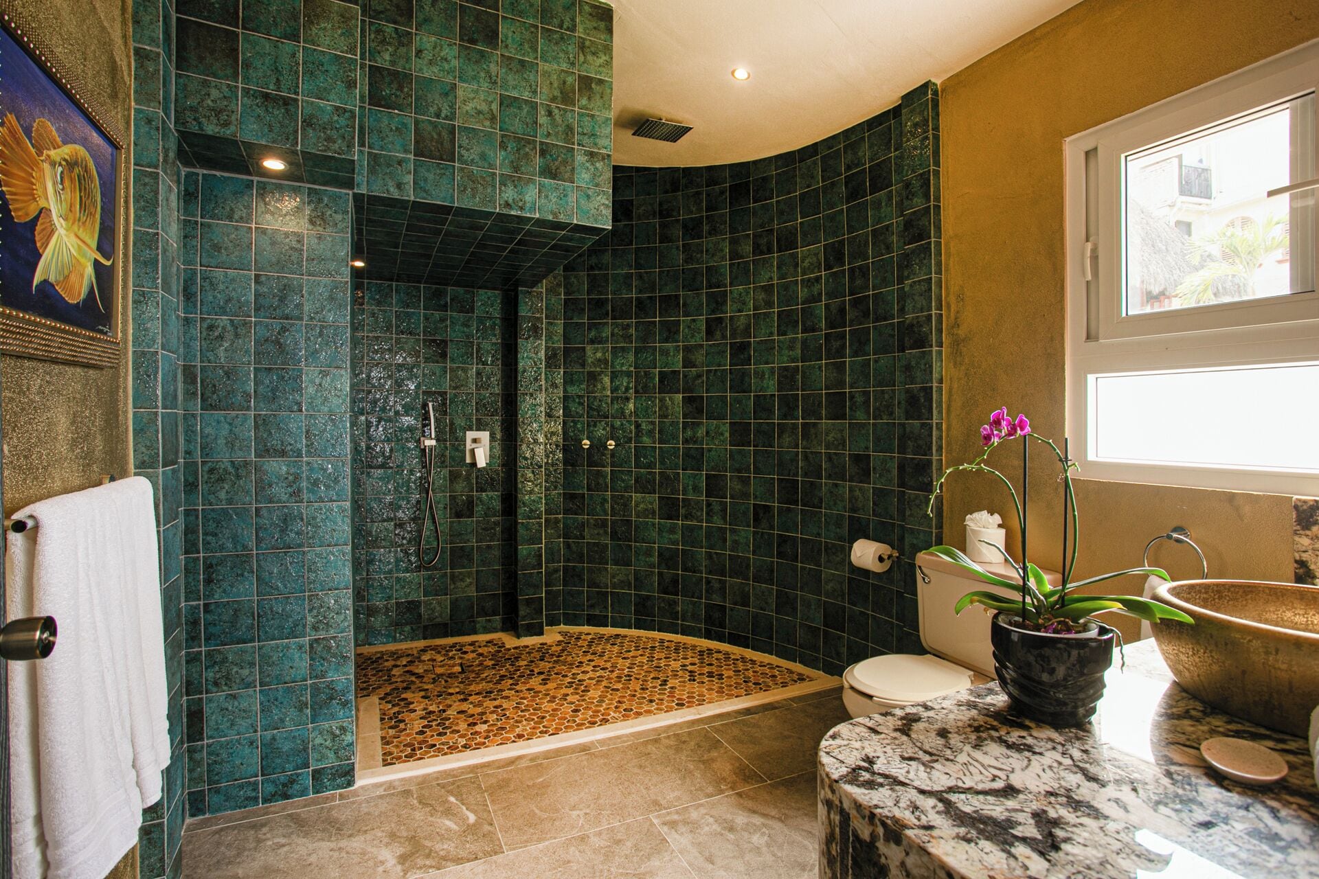 A bathroom with a shower, toilet, and sink.