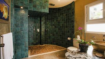 A bathroom with a shower, toilet, and sink.
