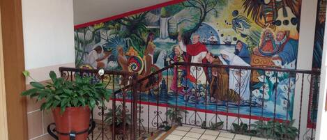 A staircase with a mural depicting a historical scene.