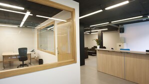 A modern office space with a reception desk, a meeting room, and a conference area. - Andorra4days Soldeu - El Tarter (Soldeu)