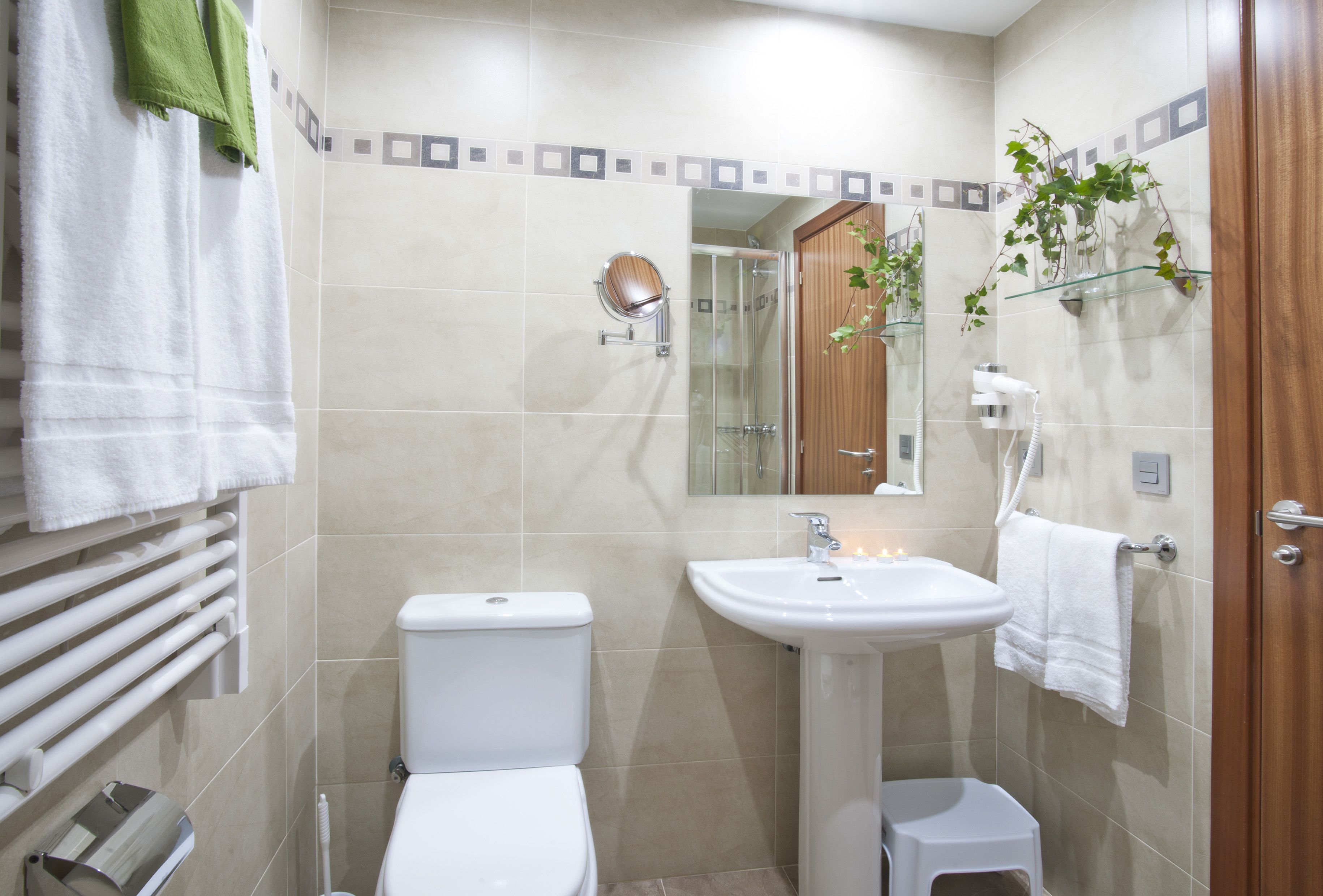 A modern bathroom with a toilet, sink, and shower.