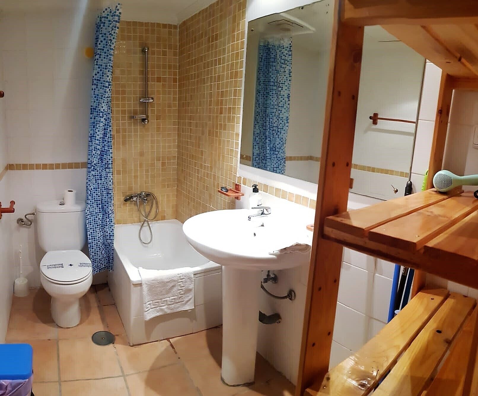 A bathroom with a toilet, bathtub, and sink.