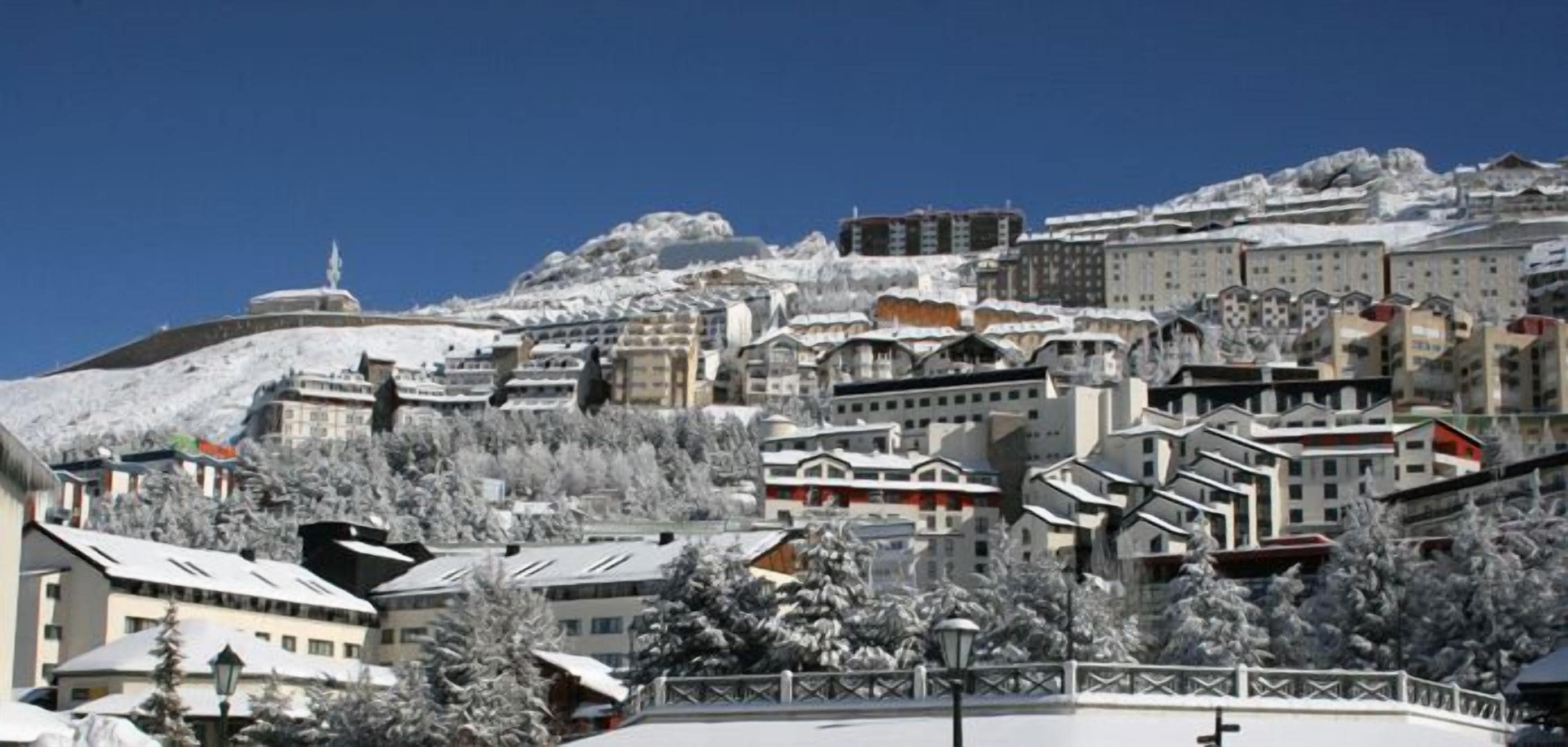 A snow-covered town with buildings, including a prominent dome structure and various residential and commercial buildings.