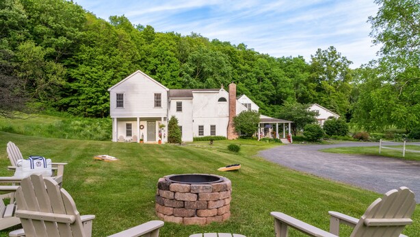 A house with a fire pit and outdoor seating.