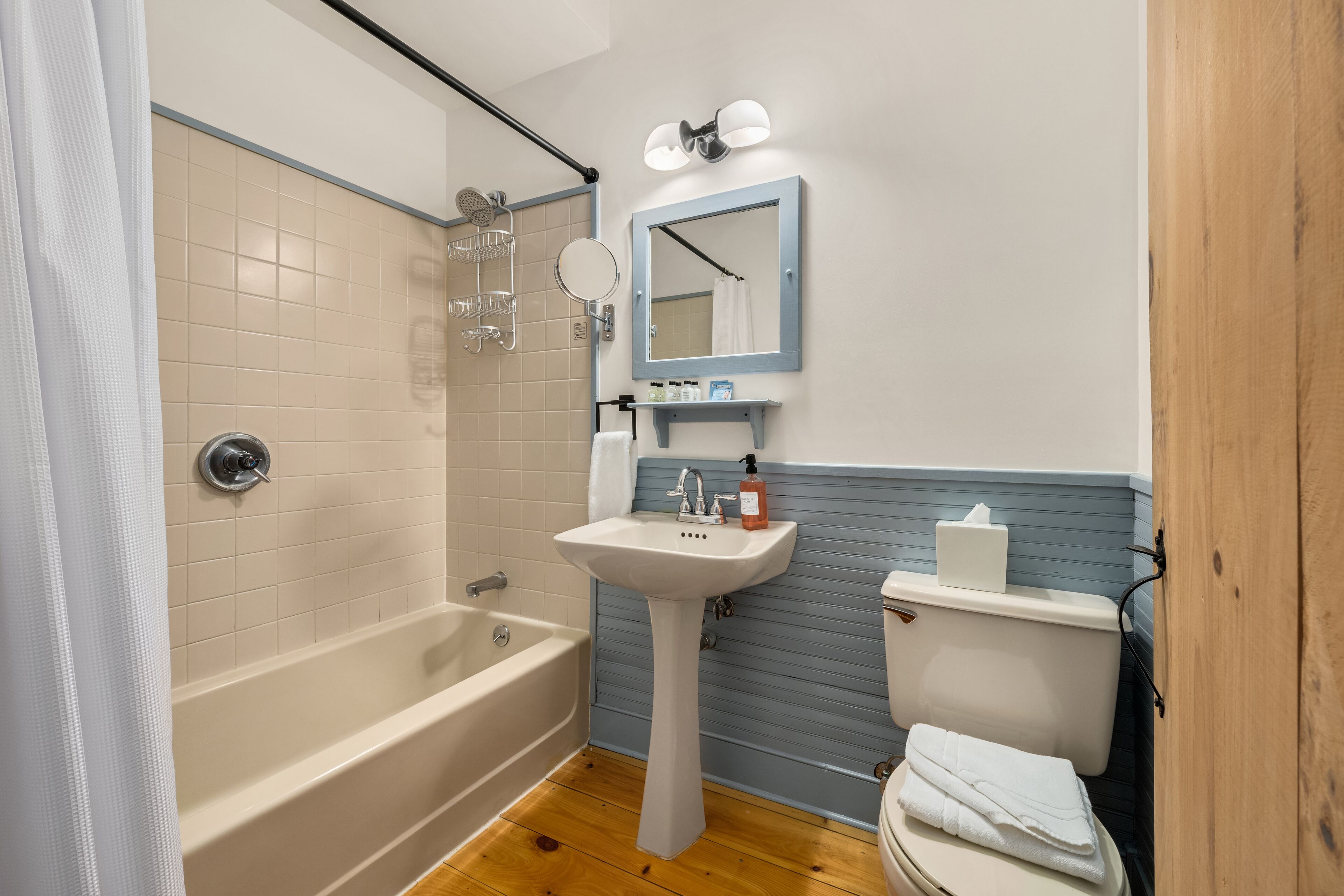 A bathroom with a bathtub, sink, and toilet.