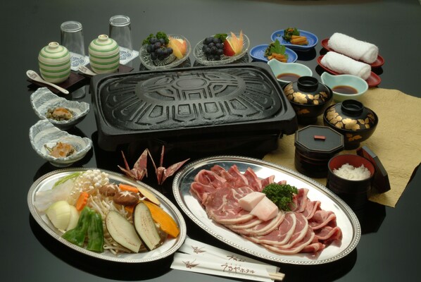 A traditional Japanese hot pot setup with various dishes and condiments.