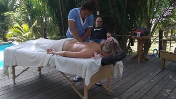 Guests can enjoy a rejuvenating massage on our serene outdoor deck overlooking the pool.