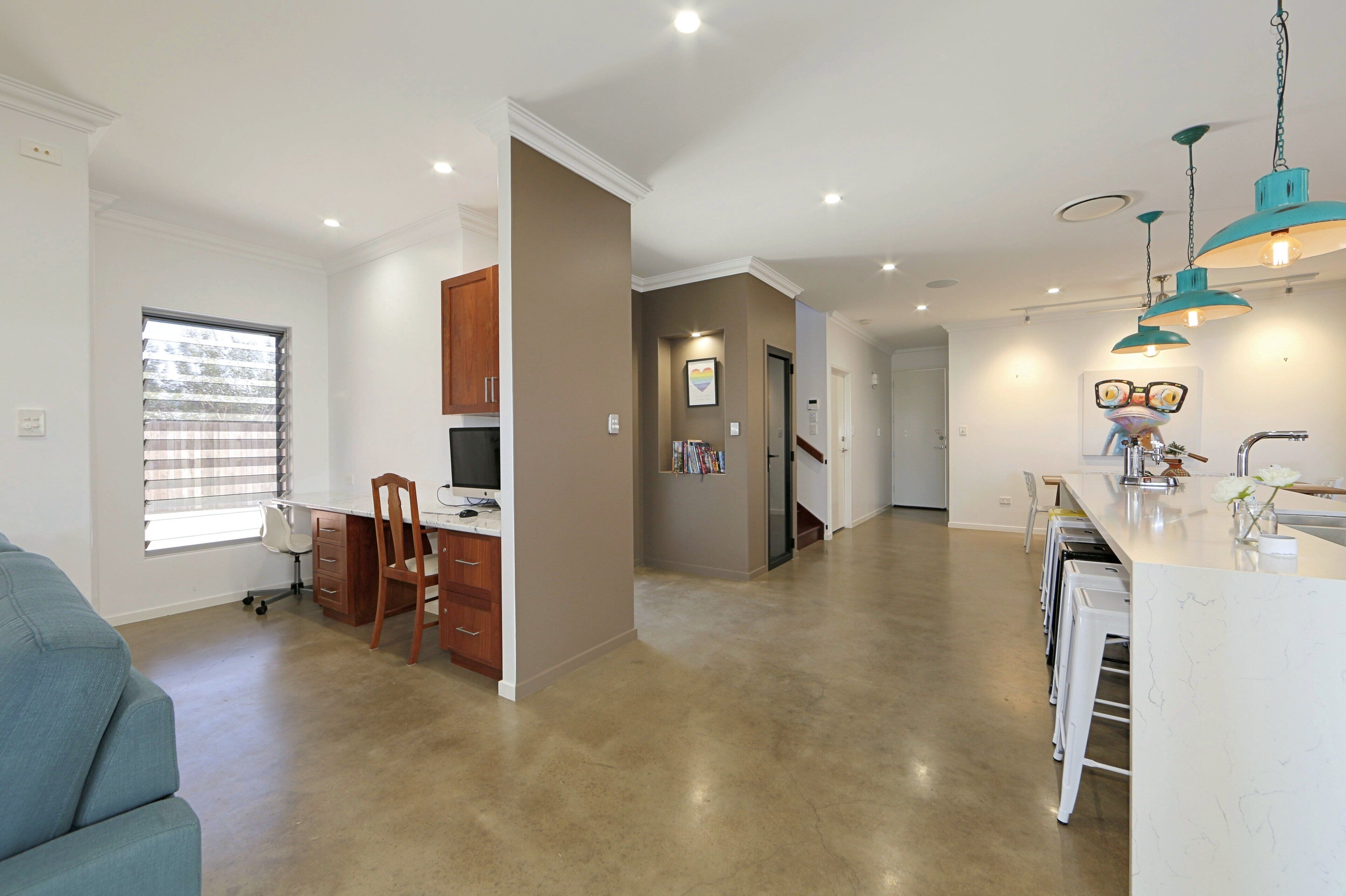 A spacious kitchen with a dining area, a small office, and a kitchenette.