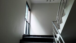 A staircase with metal railings and a window on the left. - Casa Blanca (Bangkok)