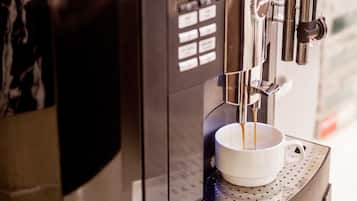 A coffee machine with a cup of coffee being dispensed.
