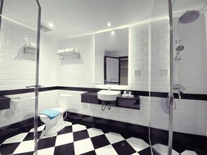 A modern bathroom with a black and white checkered floor, a white toilet, a sink, and a shower. - De Ningrat Topas Galeria (Bandung)
