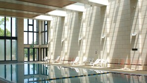 An indoor swimming pool with clear water, surrounded by tiled walls and large windows allowing natural light. - Nanki Shirahama Golf Club, Nanki Shirahama Resort Hotel (Kamitonda)