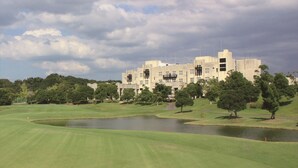 A large, historic building with a moat and lush green surroundings. - Nanki Shirahama Golf Club, Nanki Shirahama Resort Hotel (Kamitonda)