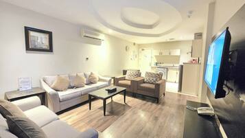 Family Apartment, 2 Bedrooms | Living area | 62-inch flat-screen TV with digital channels, TV