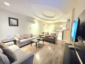 Family Apartment, 2 Bedrooms | Living area | 62-inch flat-screen TV with digital channels, TV - Aswar Hotel Suites - Al Rashed (Al Khobar)