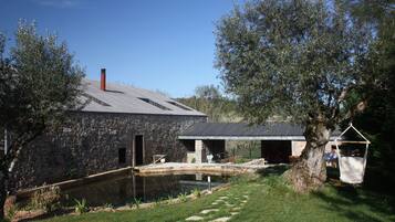 Escape to a serene retreat surrounded by lush greenery and a tranquil pond.
