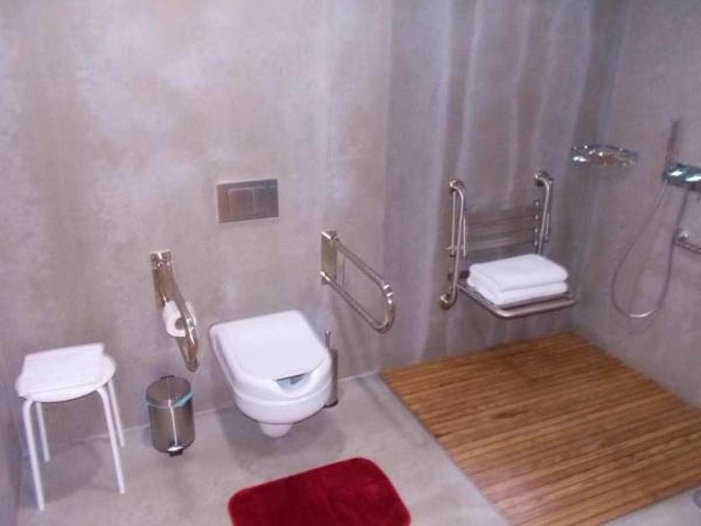 A modern bathroom with a toilet, bidet, and shower.