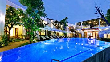 Outdoor pool, open 6 AM to 10 PM, pool umbrellas, pool loungers