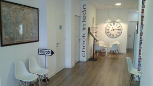 A reception area with a map, a clock, and modern chairs.