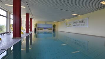 A swimming pool with red pillars, a mural, and a sign for 'Landhotel Betz Superior'.