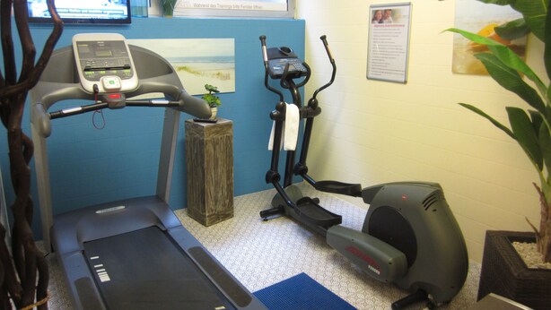 A fitness room with a treadmill, elliptical, and stationary bike. - Trip Inn Landhotel Bad Soden-Salmünster (Bad Soden-Salmuenster)