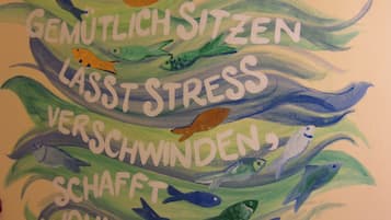 A wall with text and illustrations of fish.