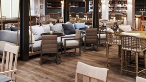 A modern lounge area with wooden flooring, comfortable seating, and a bar in the background. - Newport Harbor Island Resort (Newport)